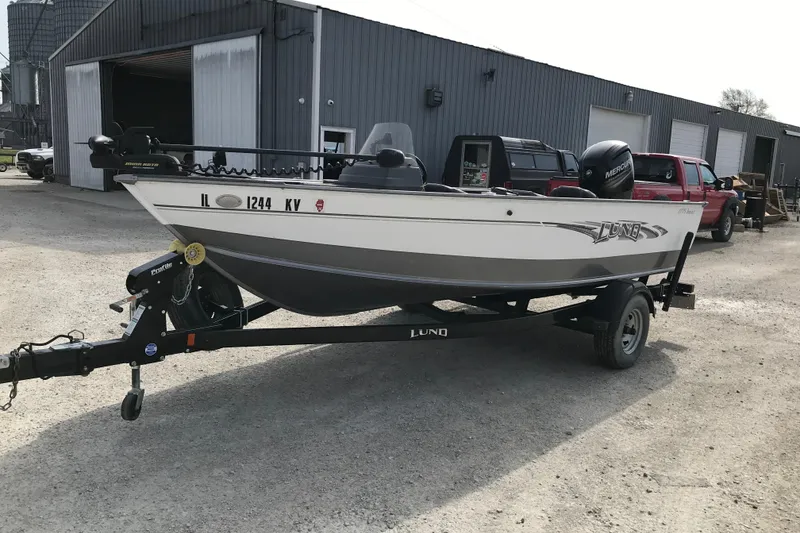 Slide: The Image of 2017 Lund 1775 Impact SS boat on trailer in industrial setting. - 10