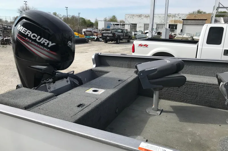 Slide: The Image of 2017 Lund 1775 Impact SS boat with Mercury FourStroke engine, parked outdoors. - 12