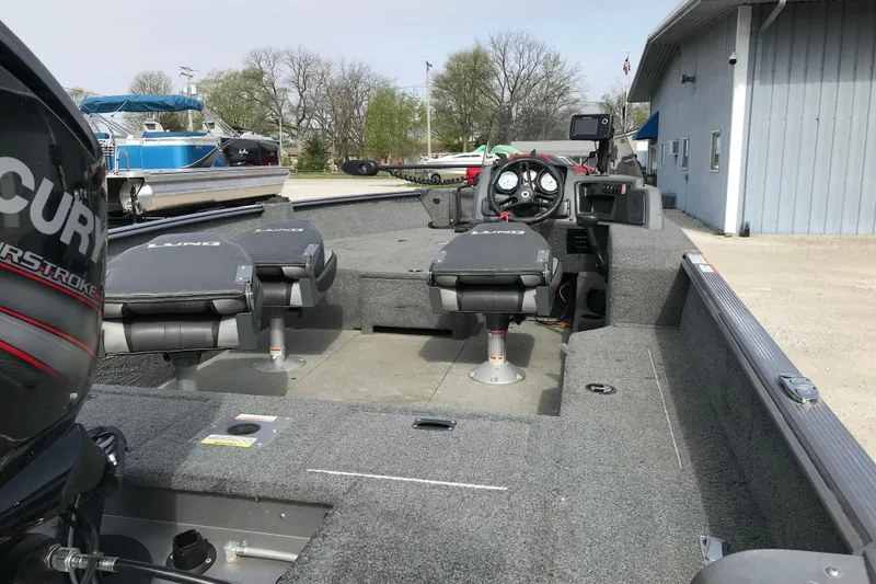 Slide: The Image of 2017 Lund 1775 Impact SS fishing boat interior with Mercury engine, dual seats, and control panel. - 13