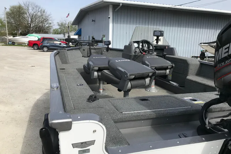 Slide: The Image of 2017 Lund 1775 Impact SS fishing boat with Mercury engine, parked outdoors. - 14