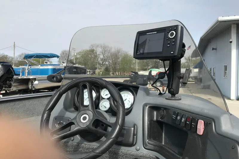 Slide: The Image of 2017 Lund 1775 Impact SS boat dashboard with steering wheel and fish finder. - 15