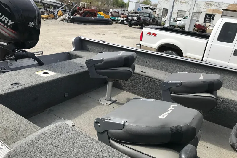 Slide: The Image of 2017 Lund 1775 Impact SS boat interior with gray seating and Mercury outboard motor. - 16