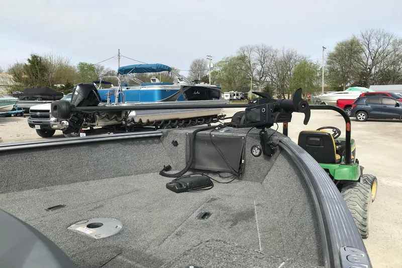 Slide: The Image of 2017 Lund 1775 Impact SS boat with trolling motor in a marina parking lot. - 17