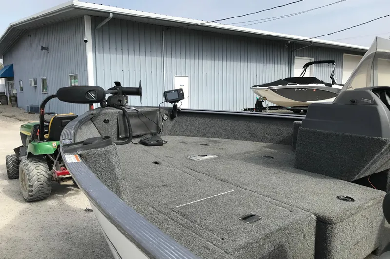 Slide: The Image of 2017 Lund 1775 Impact SS boat on trailer near metal building. - 18
