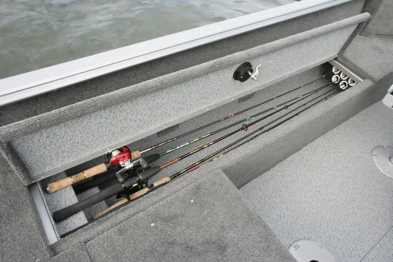 Slide: The Image of 2017 Lund 1775 Impact SS boat with outboard motor, parked near a white truck. - 4