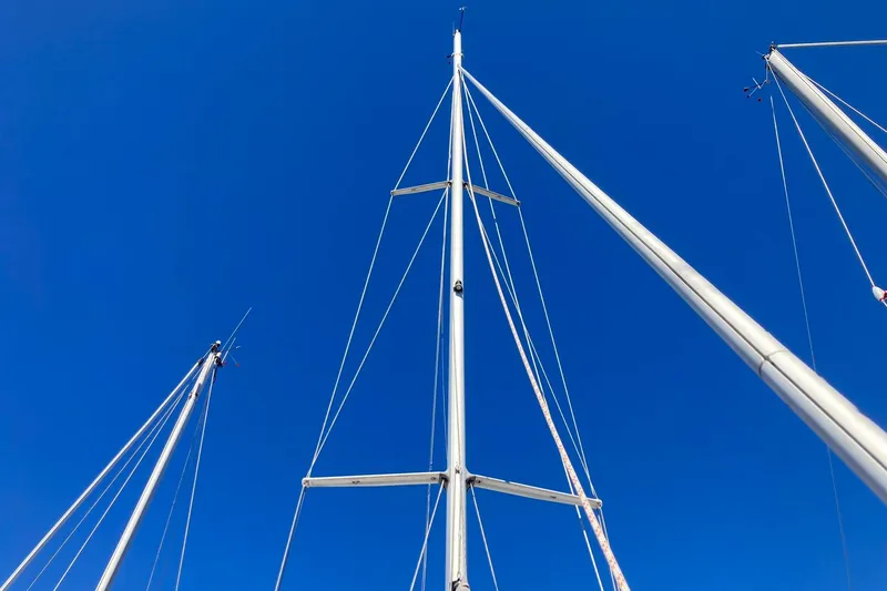 Slide: The Image of Masts of 1987 Hunter Legend 35 sailboat against clear blue sky. - 10