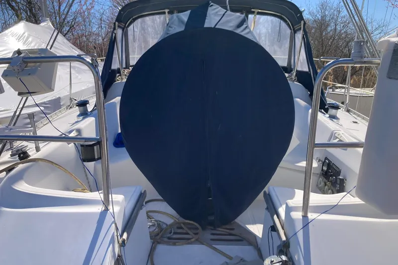 Slide: The Image of 1987 Hunter Legend 35 sailboat cockpit with blue cover and nautical equipment. - 15