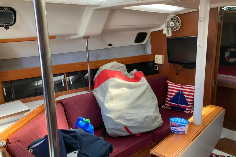 Slide: The Image of Interior of 1987 Hunter Legend 35 sailboat with seating, fan, and nautical decor. - 17