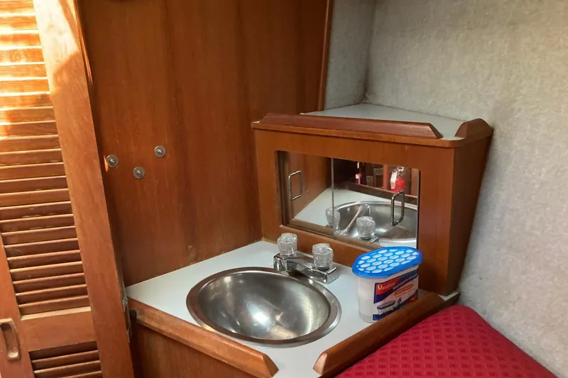 Slide: The Image of Interior of 1987 Hunter Legend 35 sailboat with wooden cabinetry and stainless steel sink. - 19