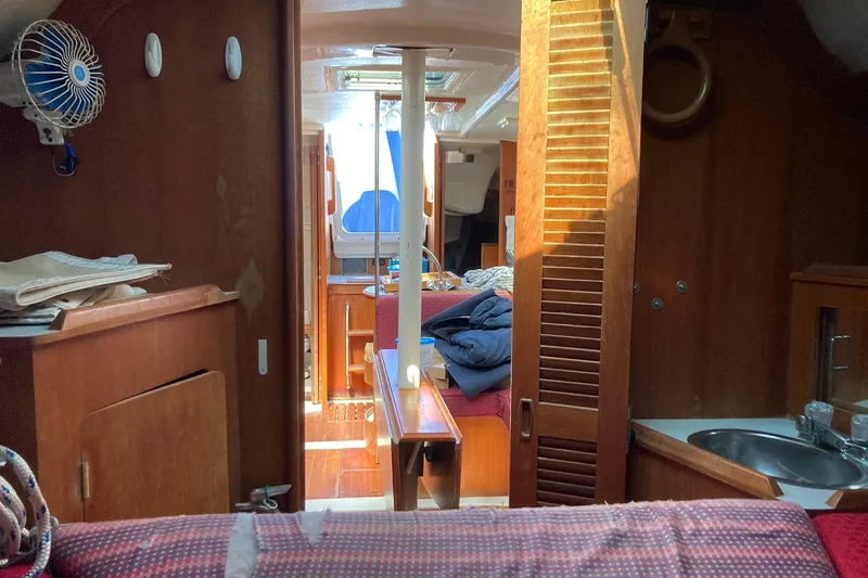 Slide: The Image of Interior of 1987 Hunter Legend 35 sailboat with wood finish and compact layout. - 20