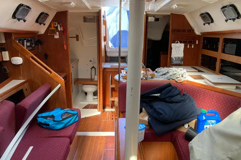 Slide: The Image of Interior of a 1987 Hunter Legend 35 sailboat with seating, storage, and a small bathroom. - 21