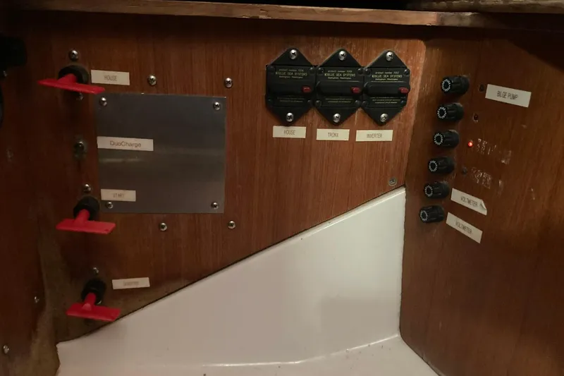 Slide: The Image of Electrical panel of a 1987 Hunter Legend 35 sailboat with labeled switches and controls. - 24