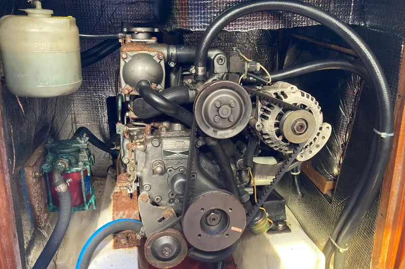 Slide: The Image of Engine compartment of a 1987 Hunter Legend 35 sailboat, showing mechanical components. - 25