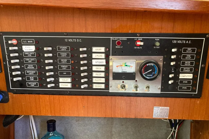 Slide: The Image of Electrical control panel of a 1987 Hunter Legend 35 sailboat, featuring switches and gauges. - 29