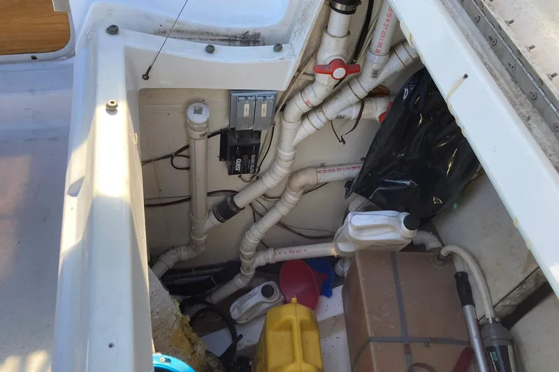 Slide: The Image of Interior view of 1987 Hunter Legend 35 sailboat showing plumbing and storage area. - 30
