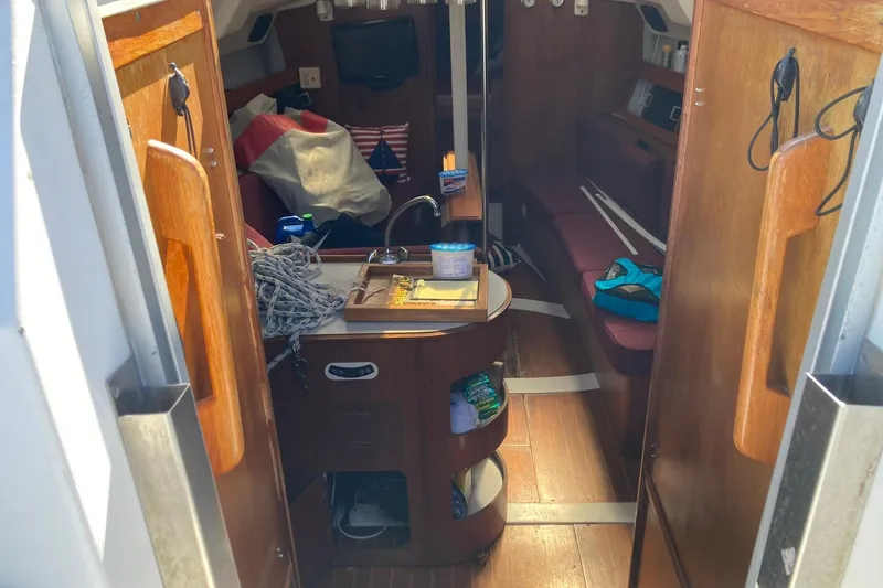 Slide: The Image of Interior of 1987 Hunter Legend 35 sailboat with wooden cabinetry and seating area. - 33