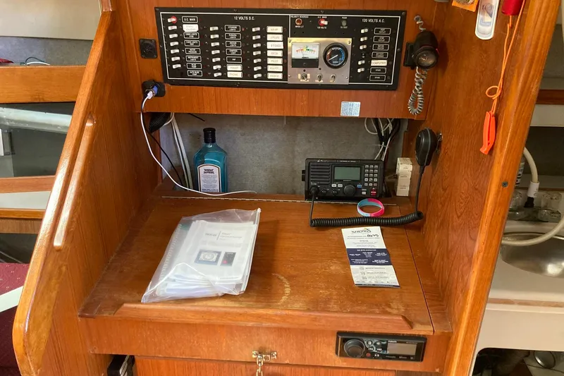 Slide: The Image of Navigation station of a 1987 Hunter Legend 35 sailboat with control panel and radio equipment. - 35