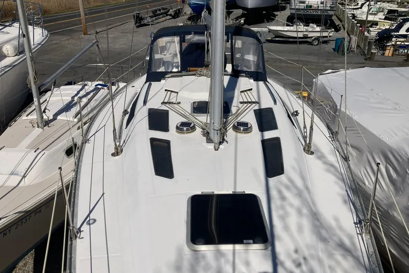 Slide: The Image of 1987 Hunter Legend 35 sailboat deck view in a marina setting. - 5