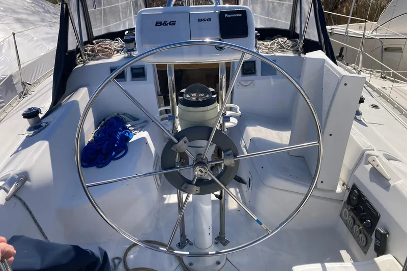 Slide: The Image of Cockpit of 1987 Hunter Legend 35 sailboat with steering wheel and navigation equipment. - 6