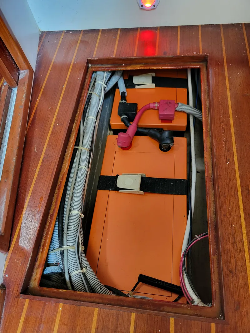 Slide: The Image of Battery compartment of 1996 Little Harbor 51 Pilothouse with orange batteries and wiring. - 45