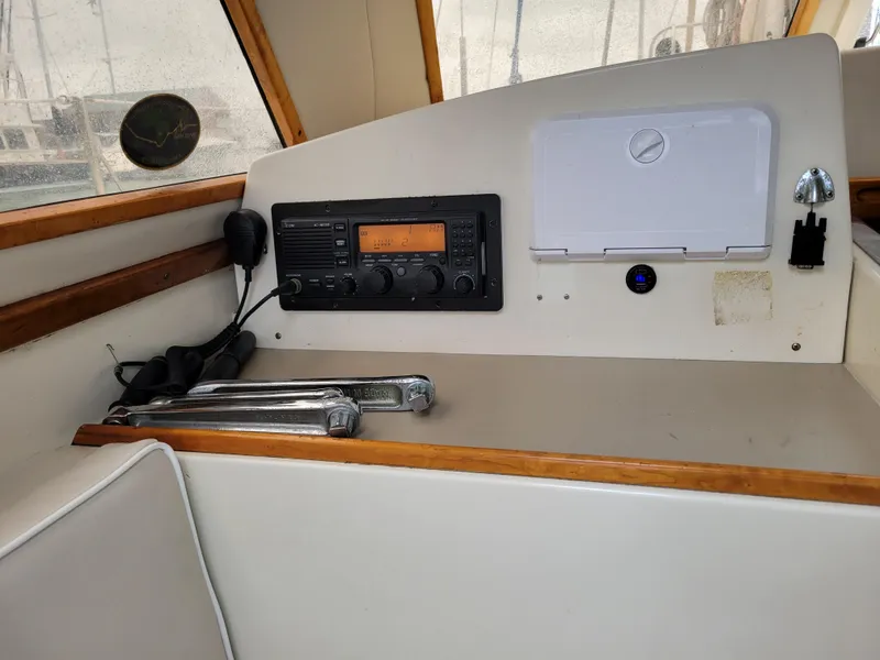 Slide: The Image of 1996 Little Harbor 51 Pilothouse interior with radio equipment and navigation tools. - 24