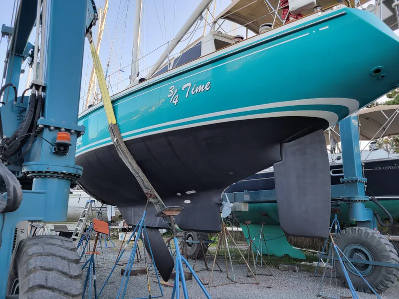 Slide: The Image of Little Harbor 51 Pilothouse sailboat from 1996 in dry dock, turquoise hull, supported by stands. - 8