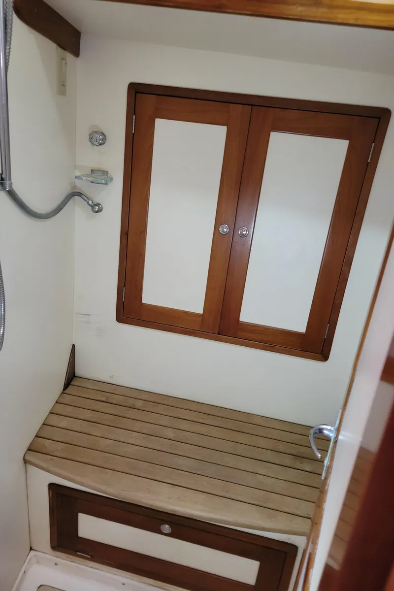 Slide: The Image of 1996 Little Harbor 51 Pilothouse shower area with wooden accents and storage. - 37