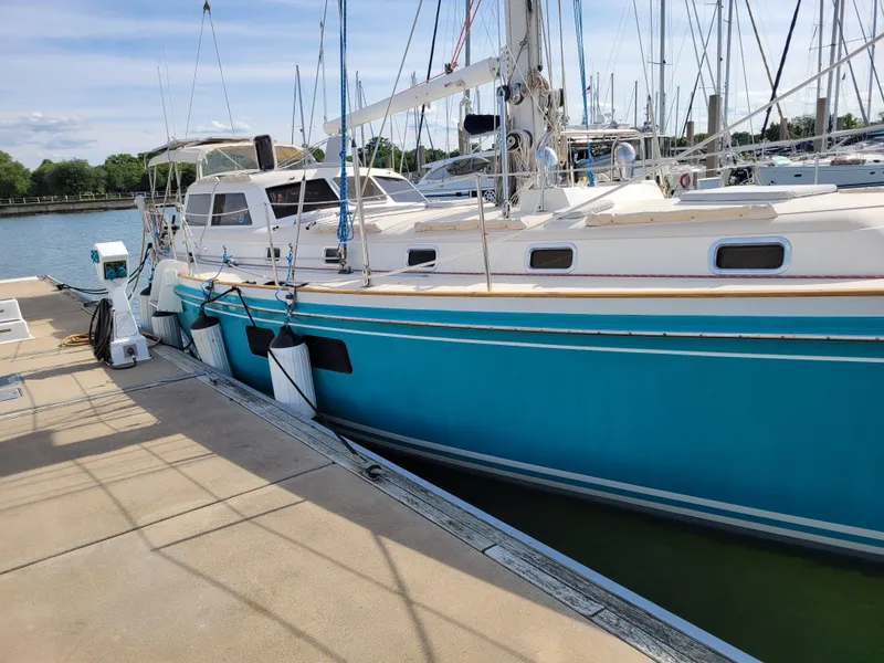 Slide: The Image of 1996 Little Harbor 51 Pilothouse yacht docked at marina, featuring a sleek blue hull. - 3