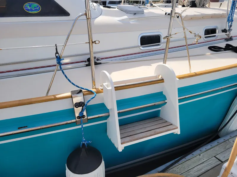 Slide: The Image of Boarding ladder on a 1996 Little Harbor 51 Pilothouse yacht, featuring teal and white accents. - 6