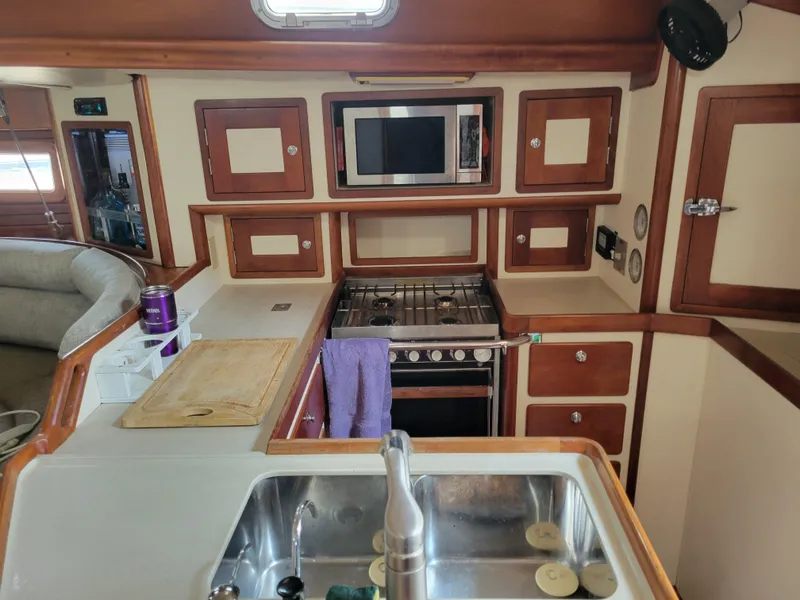 Slide: The Image of Interior of 1996 Little Harbor 51 Pilothouse yacht kitchen with stove, sink, and microwave. - 27