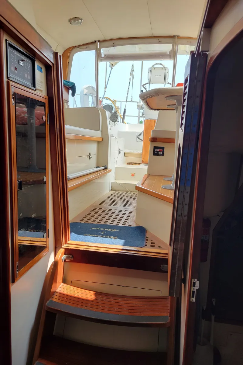 Slide: The Image of Interior view of 1996 Little Harbor 51 Pilothouse, showcasing wooden steps and seating area. - 26