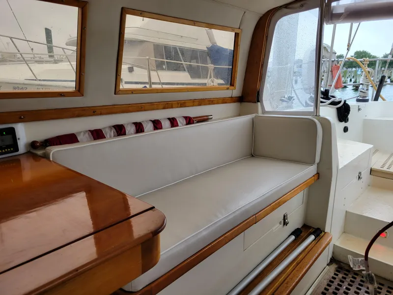 Slide: The Image of Interior of 1996 Little Harbor 51 Pilothouse with cushioned seating and wooden accents. - 19