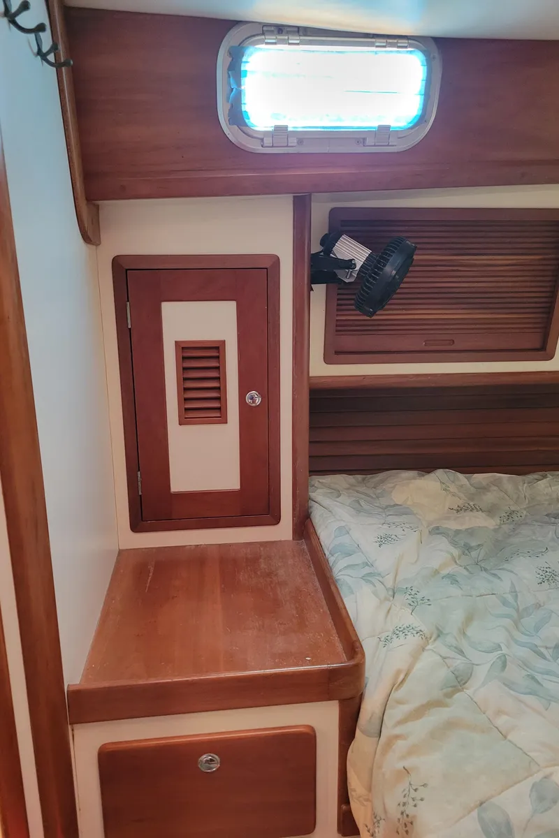 Slide: The Image of Cozy cabin interior of 1996 Little Harbor 51 Pilothouse with wooden accents and bedding. - 34