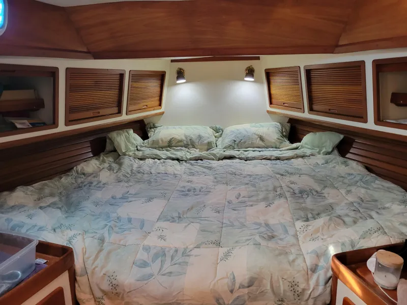 Slide: The Image of Cozy bedroom in 1996 Little Harbor 51 Pilothouse yacht with wood paneling and floral bedding. - 33