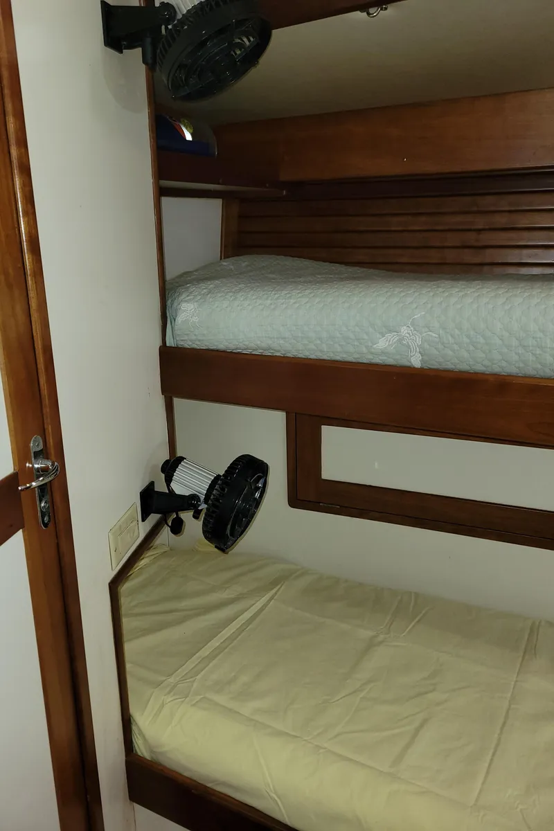 Slide: The Image of Bunk beds in 1996 Little Harbor 51 Pilothouse yacht cabin with fans and wooden accents. - 41