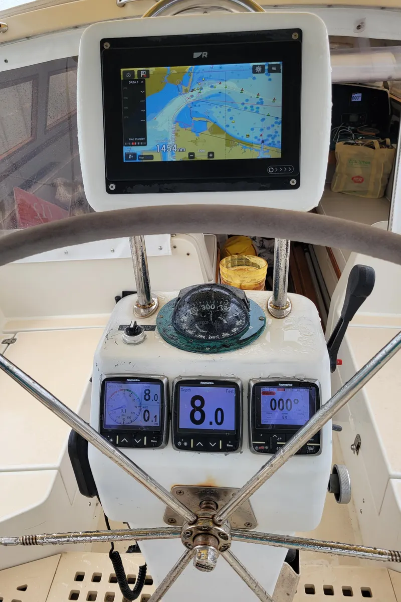 Slide: The Image of Helm of 1996 Little Harbor 51 Pilothouse with navigation instruments and steering wheel. - 15