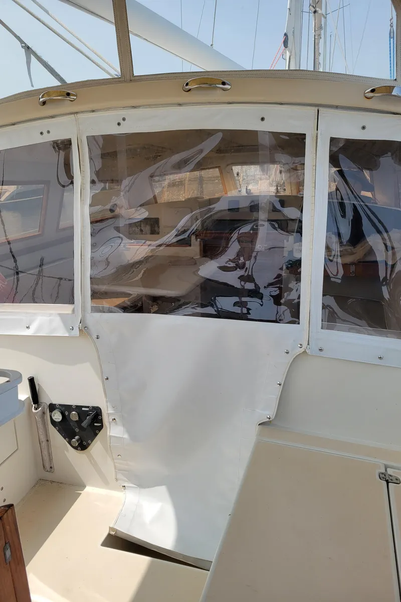 Slide: The Image of 1996 Little Harbor 51 Pilothouse interior with clear panels and beige seating. - 16
