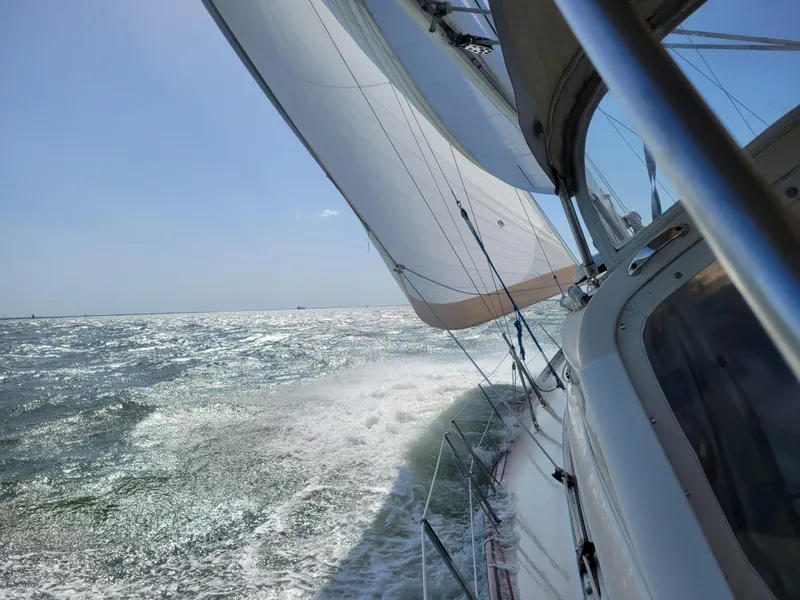 Slide: The Image of Sailing on a 1996 Little Harbor 51 Pilothouse, cutting through waves under clear skies. - 7