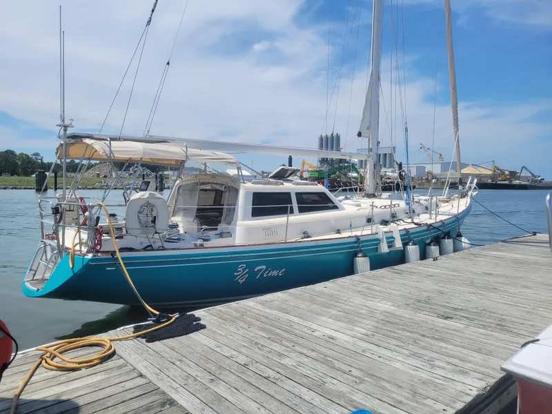 Slide: The Image of 1996 Little Harbor 51 Pilothouse yacht docked at a marina under a clear blue sky. - 4