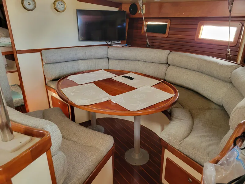 Slide: The Image of Cozy interior of 1996 Little Harbor 51 Pilothouse with cushioned seating and wooden table. - 31