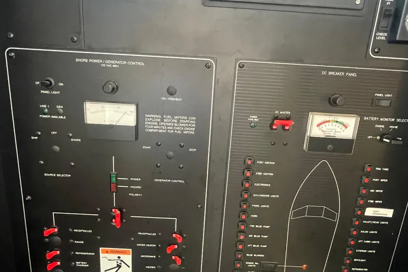 Slide: The Image of Control panel of a 2001 Bayliner 3388 Command Bridge Motoryacht, featuring shore power and generator controls. - 10