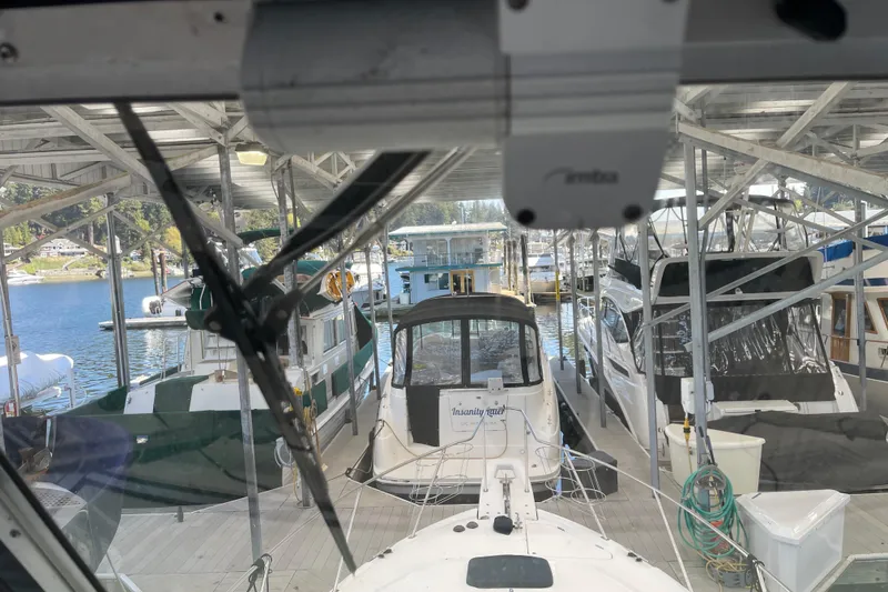 Slide: The Image of 2001 Bayliner 3388 Command Bridge Motoryacht docked in a covered marina. - 37