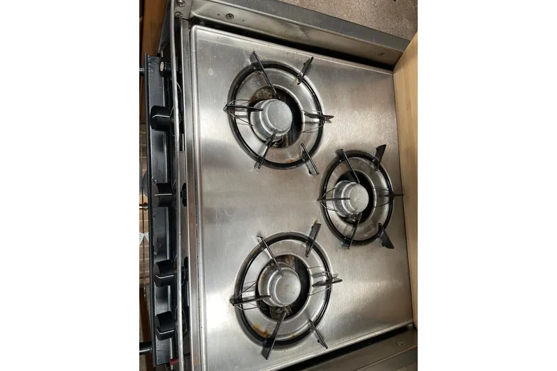 Slide: The Image of Stainless steel three-burner stove on 2001 Bayliner 3388 Command Bridge Motoryacht. - 53