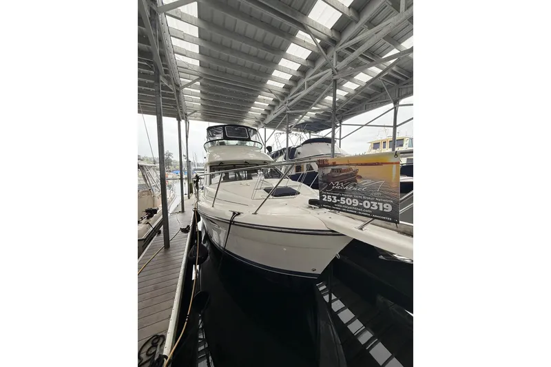 Slide: The Image of 2001 Bayliner 3388 Command Bridge Motoryacht docked under covered marina. - 62