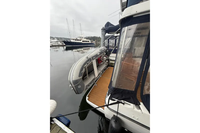 Slide: The Image of 2001 Bayliner 3388 Command Bridge Motoryacht docked with inflatable dinghy attached. - 65
