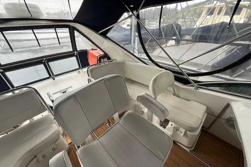 Slide: The Image of 2001 Bayliner 3388 Command Bridge Motoryacht interior with white seating and panoramic windows. - 69