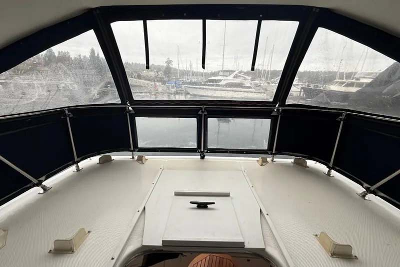 Slide: The Image of 2001 Bayliner 3388 Command Bridge Motoryacht interior with marina view through windows. - 70