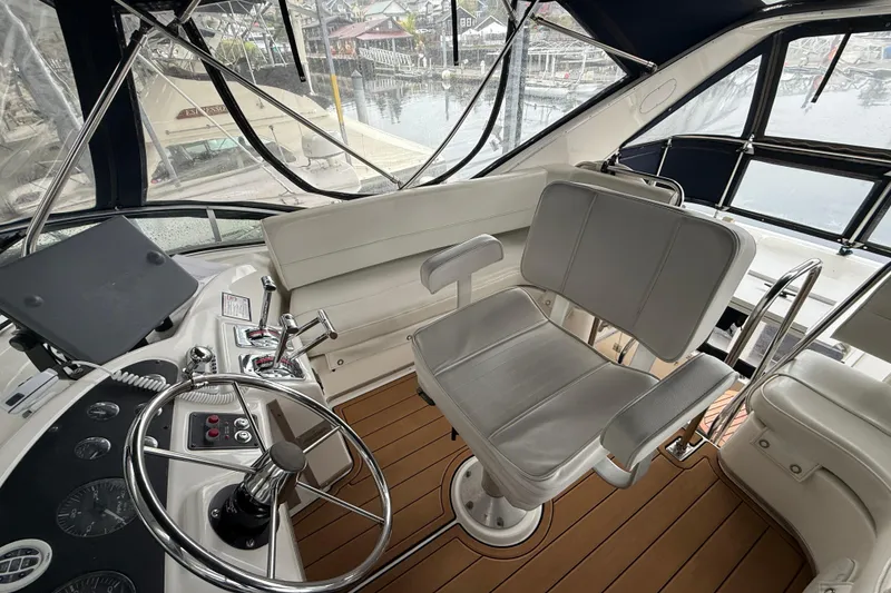 Slide: The Image of 2001 Bayliner 3388 Command Bridge Motoryacht helm with steering wheel and captain's chair. - 71