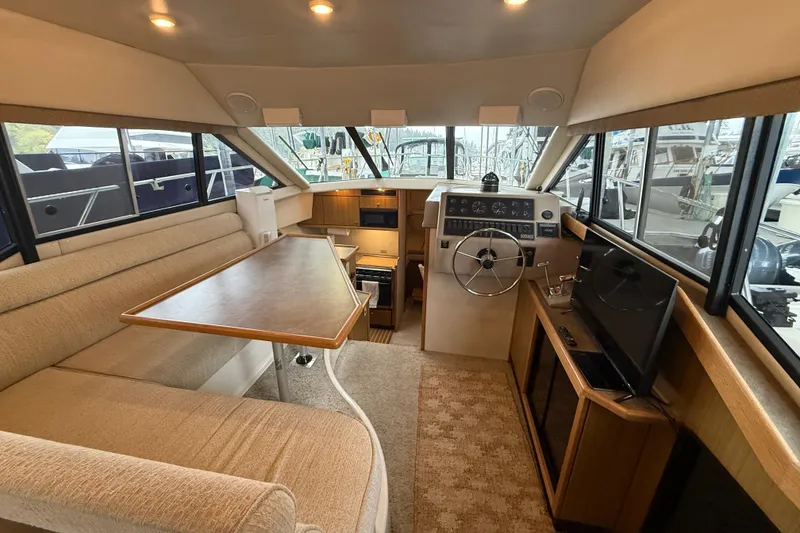 Slide: The Image of Interior of 2001 Bayliner 3388 Command Bridge Motoryacht with helm, seating, and table. - 73