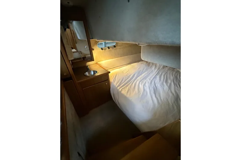 Slide: The Image of Cozy cabin interior of 2001 Bayliner 3388 Command Bridge Motoryacht with bed and sink. - 74